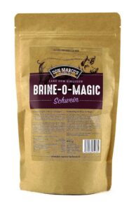 Schwein Brine O Magic in braunem Kraftpapier Beutel. Großes Etikett in Front mit gezeichnetem Schwein im Hintergrund